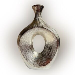 Textured silver vase, geometric oval shape with center cut out. Modern, sleek.